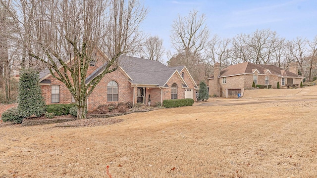 view of front of home featuring a garage and a front lawn