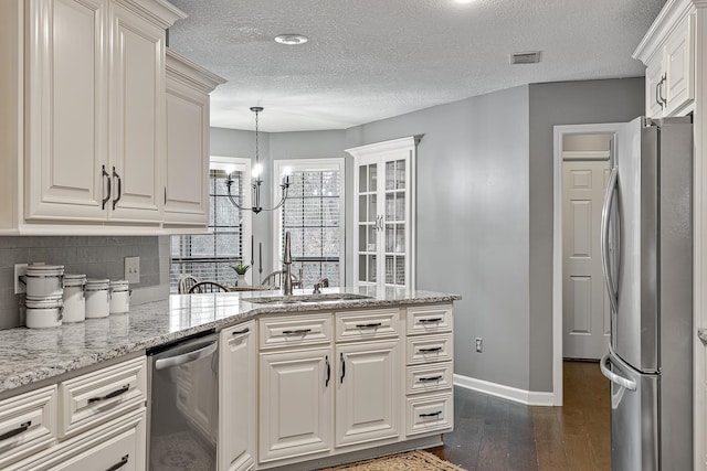 kitchen with sink, white cabinets, dark hardwood / wood-style flooring, stainless steel appliances, and light stone countertops