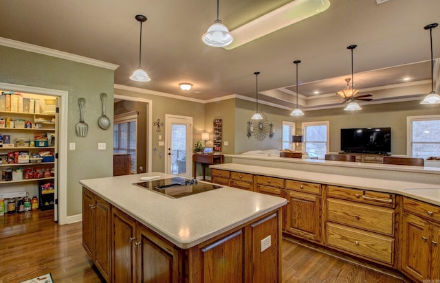 kitchen featuring pendant lighting, a center island, hardwood / wood-style floors, and black electric cooktop