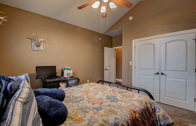 carpeted bedroom with lofted ceiling, a closet, and ceiling fan