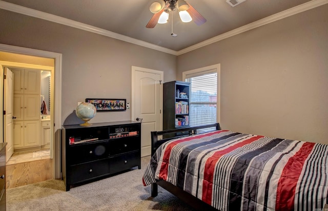 bedroom with ornamental molding, light carpet, ensuite bathroom, and ceiling fan