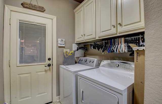 laundry area featuring cabinets and washing machine and clothes dryer