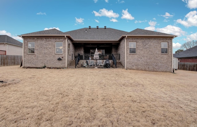 rear view of property with a lawn