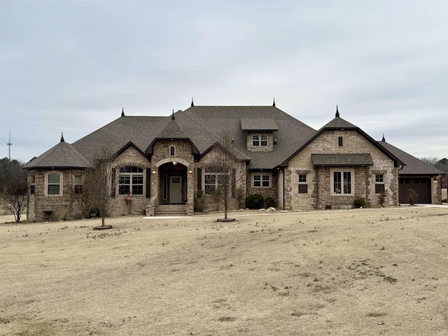 french country inspired facade featuring a garage