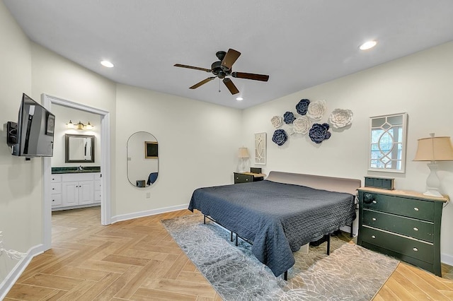 bedroom featuring light parquet floors, ensuite bathroom, sink, and ceiling fan