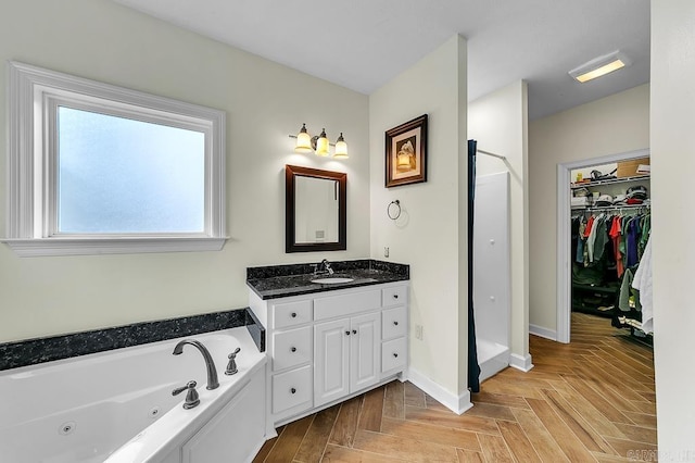 bathroom with vanity, parquet floors, and a washtub