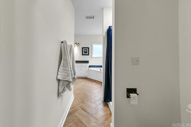 bathroom with parquet flooring