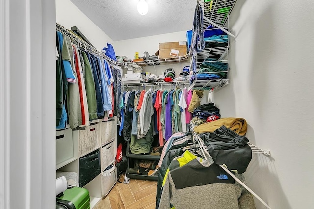 spacious closet with parquet flooring