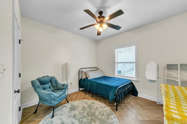 bedroom featuring parquet flooring and ceiling fan