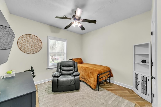 bedroom featuring ceiling fan and parquet flooring