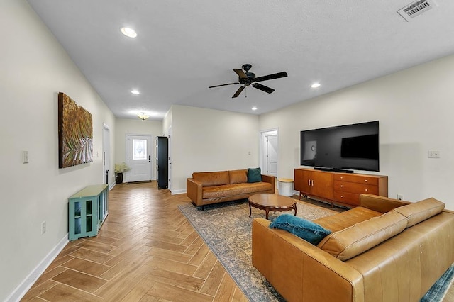 living room featuring parquet floors and ceiling fan