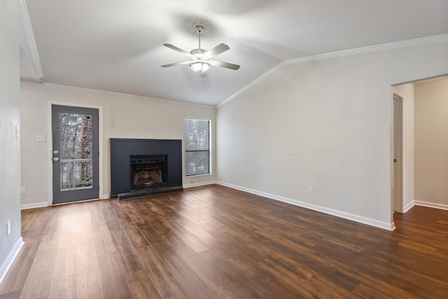 unfurnished living room featuring lofted ceiling, crown molding, a wealth of natural light, and dark hardwood / wood-style floors