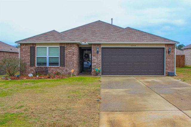 ranch-style house with a garage and a front yard