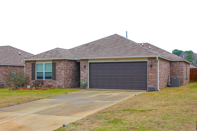 ranch-style home featuring central AC, a garage, and a front lawn