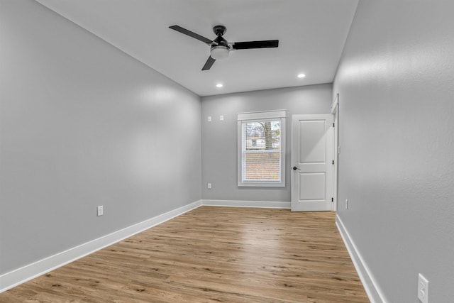 spare room featuring light hardwood / wood-style flooring and ceiling fan