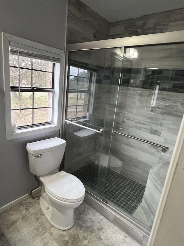 bathroom with toilet and walk in shower