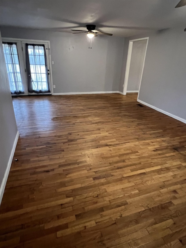 spare room featuring dark hardwood / wood-style floors and ceiling fan