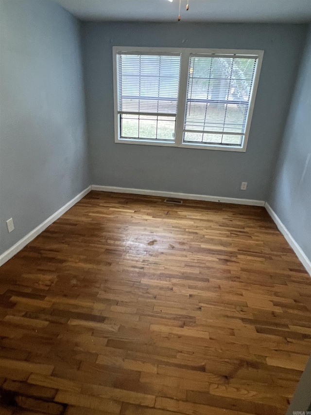 unfurnished room featuring dark wood-type flooring