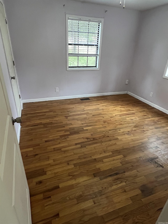 unfurnished room with dark hardwood / wood-style floors