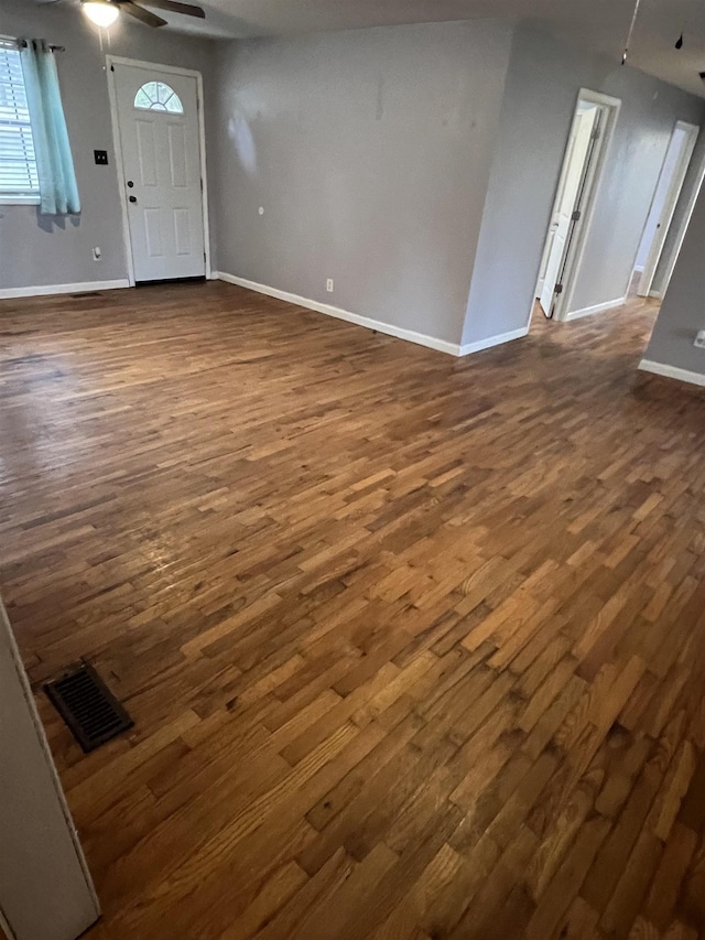 entryway with dark hardwood / wood-style floors and ceiling fan