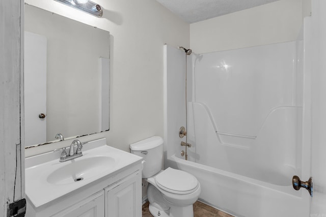 bathroom featuring shower / bath combination, vanity, toilet, and a textured ceiling