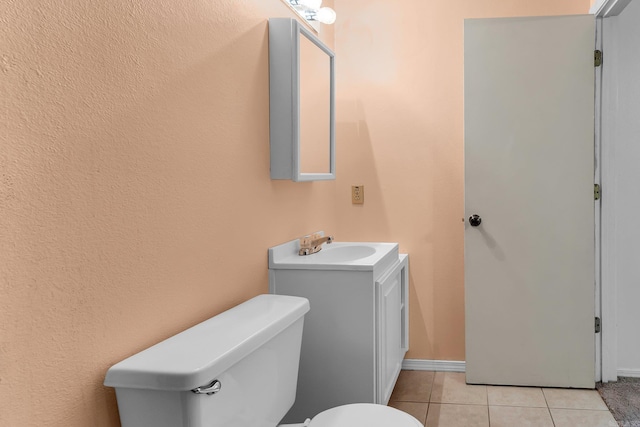 bathroom featuring vanity, tile patterned flooring, and toilet