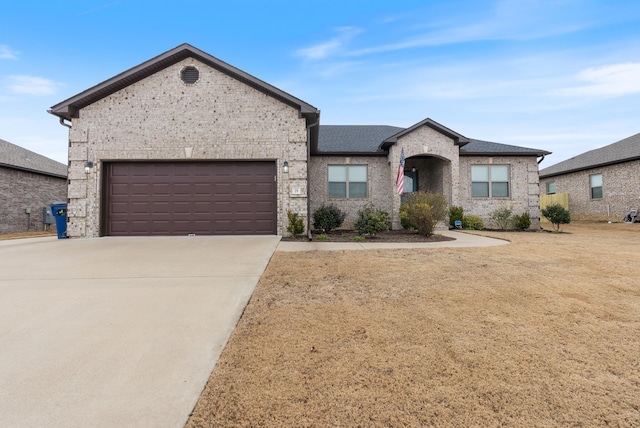 view of front of property featuring a garage and a front lawn