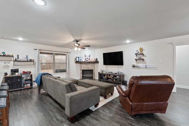 living room with dark wood-type flooring, ceiling fan, and ornamental molding