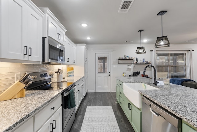 kitchen with sink, white cabinetry, green cabinetry, crown molding, and stainless steel appliances