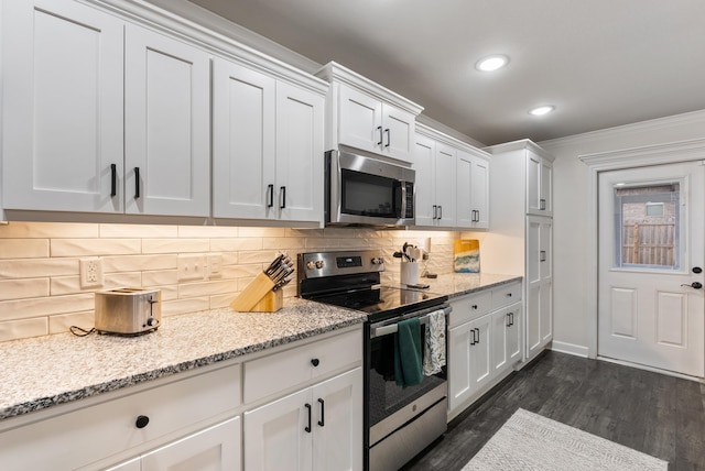 kitchen featuring light stone counters, white cabinets, and appliances with stainless steel finishes