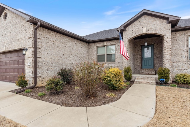 view of exterior entry with a garage