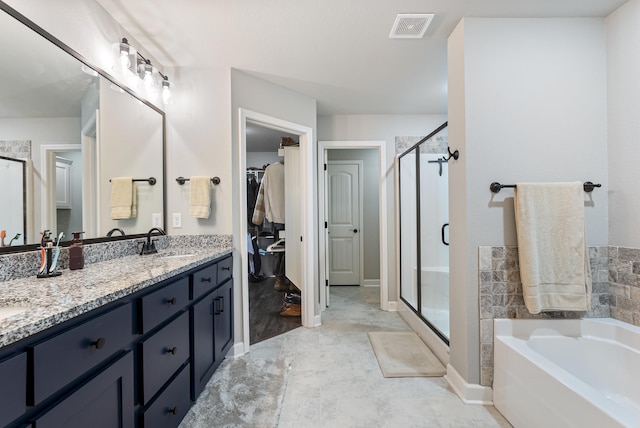 bathroom featuring vanity and shower with separate bathtub