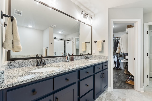 bathroom featuring vanity and an enclosed shower