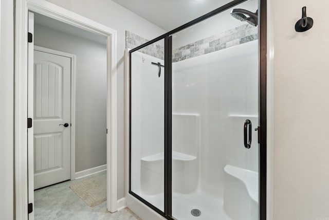 bathroom featuring a shower with door and tile patterned flooring