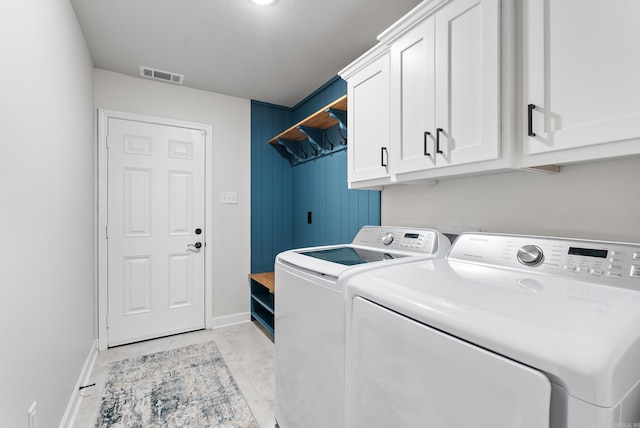 laundry room with cabinets and separate washer and dryer