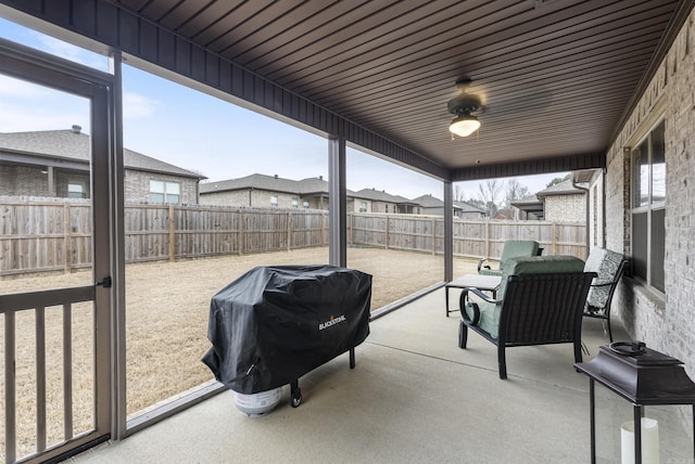 sunroom / solarium featuring ceiling fan