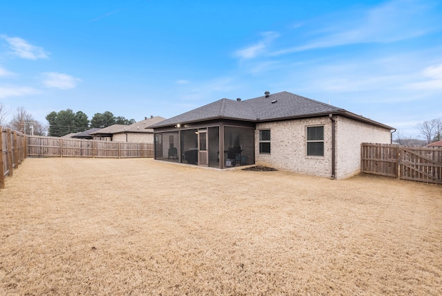 rear view of property featuring a sunroom