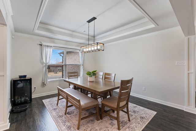 dining space with crown molding, dark hardwood / wood-style floors, and a raised ceiling