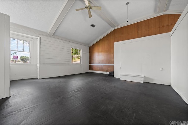 bonus room featuring vaulted ceiling with beams, ceiling fan, and wood walls