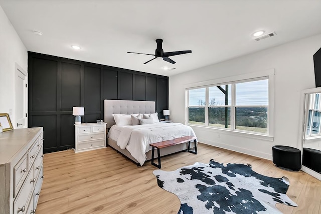 bedroom with ceiling fan and light hardwood / wood-style flooring