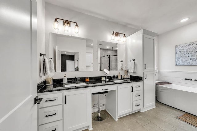 bathroom with vanity and separate shower and tub