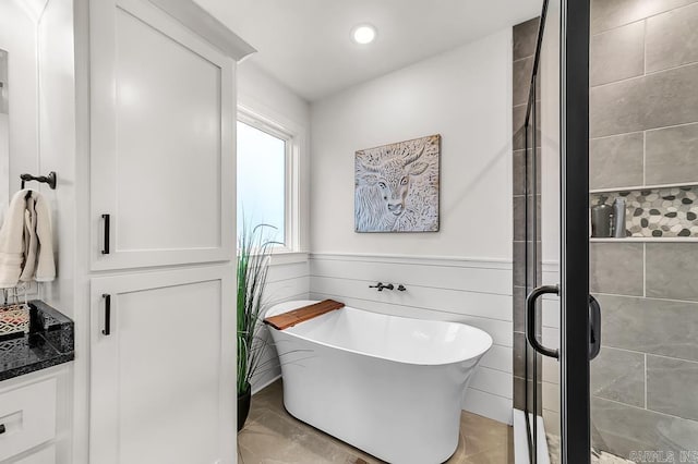 bathroom featuring vanity and separate shower and tub