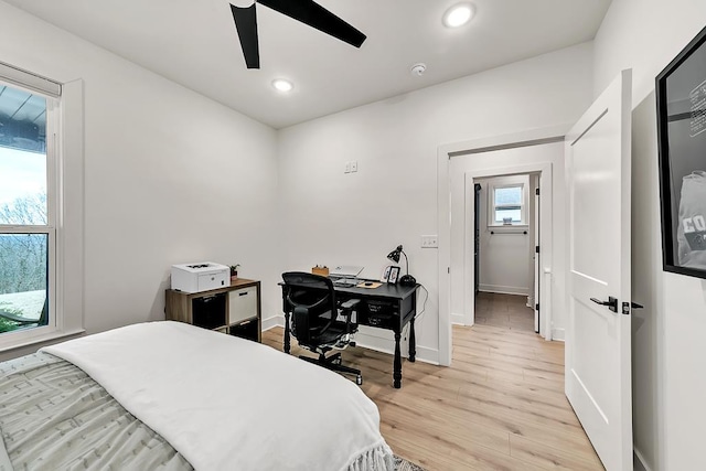 bedroom with ceiling fan and light wood-type flooring