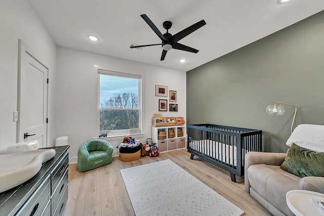 bedroom featuring ceiling fan and light hardwood / wood-style flooring