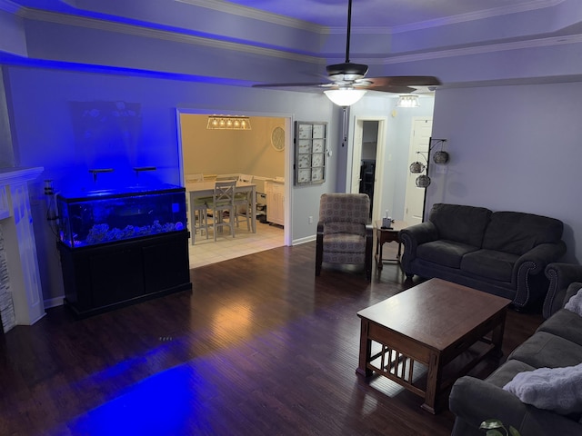 living room with hardwood / wood-style flooring, crown molding, ceiling fan, and a tray ceiling