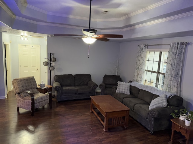 living room with a raised ceiling, crown molding, and dark hardwood / wood-style floors