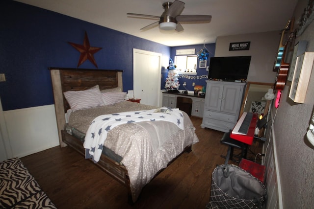 bedroom with dark hardwood / wood-style flooring and ceiling fan