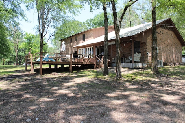 back of house with a deck