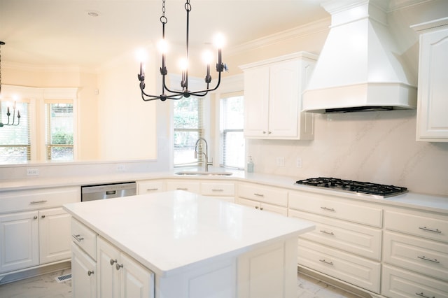 kitchen featuring dishwasher, an inviting chandelier, a center island, gas stovetop, and custom range hood