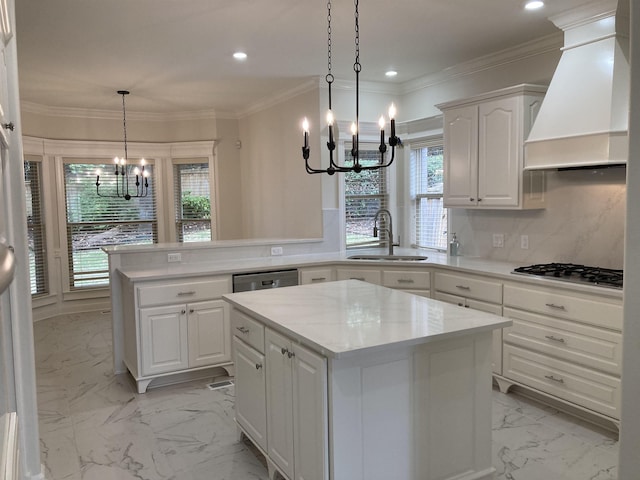 kitchen featuring premium range hood, a kitchen island, sink, white cabinets, and kitchen peninsula